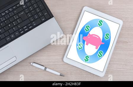 Saving money concept shown on a digital tablet Stock Photo