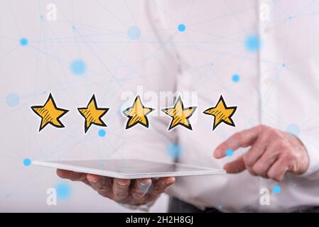 Quality concept above a tablet held by a man in background Stock Photo
