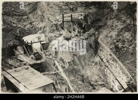 Bloomdale China Clay and Stone Works, St Stephen-in-Brannel, Cornwall, 1919-1936. A truck waiting to be taken up the haulage incline to deposit waste at a sky-dump at Bloomdale China Clay and Stone Works. This photograph forms part of a set within the album documenting the china clay industry of Cornwall, particularly focusing on the area around St Austell. China clay - also called kaolin - was used to make porcelain. The china clay industry was one of the main extractive industries in Cornwall. The images are accompanied by handwritten notes and descriptions of the processes involved in the p Stock Photo