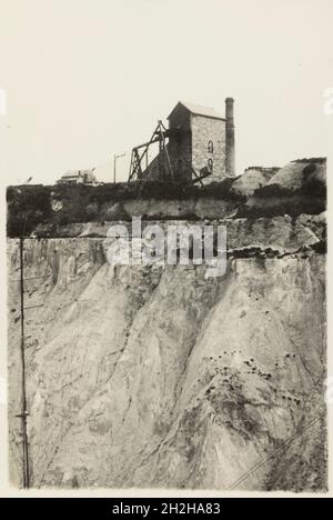 Bloomdale China Clay and Stone Works, St Stephen-in-Brannel, Cornwall, 1919-1936. A view looking across the pit towards the engine house from which the slurry pump is operated, at Bloomdale China Clay and Stone Works. This photograph forms part of a set within the album documenting the china clay industry of Cornwall, particularly focusing on the area around St Austell. China clay - also called kaolin - was used to make porcelain. The china clay industry was one of the main extractive industries in Cornwall. The images are accompanied by handwritten notes and descriptions of the processes invo Stock Photo