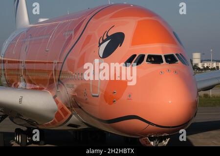 Pilots wave from the cockpit of ANA's the 3rd Airbus A380 (JA383A