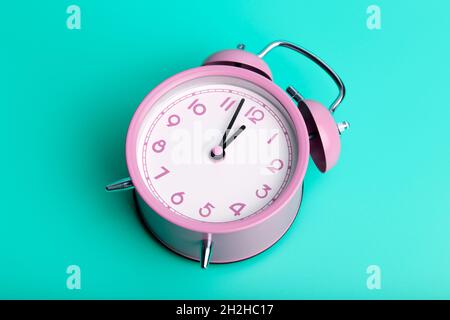 Vintage retro alarm clock on a blank colored minimal background. Time, clock, timing concept. High quality photo Stock Photo
