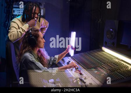 Singer Work Environment Singer with headphones recording new album at a recording studio Stock ...