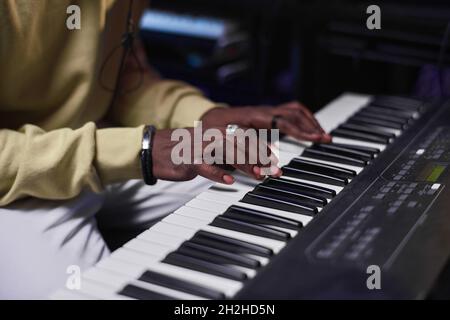 Close-up of African musician playing electric piano in the music studio Stock Photo