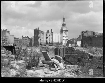 St Mary-le-Bow Church, Cheapside, City and County of the City of London, Greater London Authority, 1941-1945. A view looking north-east across a bomb damaged landscape towards St Mary-le-Bow Church. St Mary-le-Bow was rebuilt by Christopher Wren after the Great Fire of London in 1666. During the Second World War it was almost destroyed by bombing on 10th May 1941 with incendiary bombs causing a fire which sent the bells in its tower crashing down to the ground. The tower was left standing and restoration of the church began in 1956.