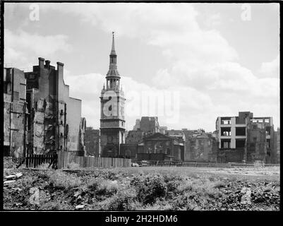 St Mary-le-Bow Church, Cheapside, City and County of the City of London, Greater London Authority, 1941-1945. A view looking east across a bomb damaged landscape towards St Mary-le-Bow Church. St Mary-le-Bow was rebuilt by Christopher Wren after the Great Fire of London in 1666. During the Second World War it was almost destroyed by bombing on 10th May 1941 with incendiary bombs causing a fire which sent the bells in its tower crashing down to the ground. The tower was left standing and restoration of the church began in 1956.