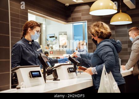 Customer paying for the order at McDonald's restaurant.  Stock Photo