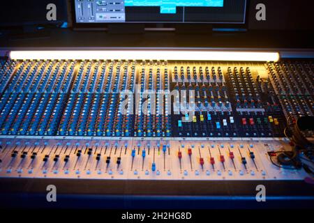 Close-up of professional audio mixing console with computer in digital recording studio Stock Photo