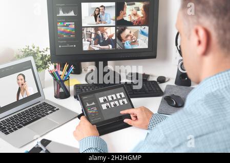 Photographer working with photos, selecting, retouching. Professional photography Stock Photo