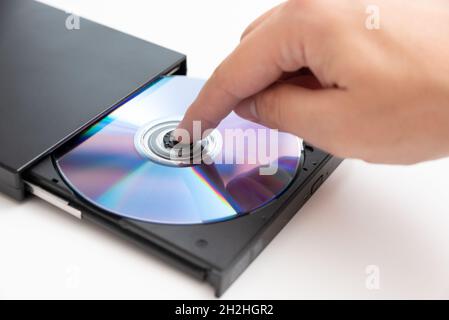 External DVD drive reader, man putting disc. Data security, digital data storage Stock Photo