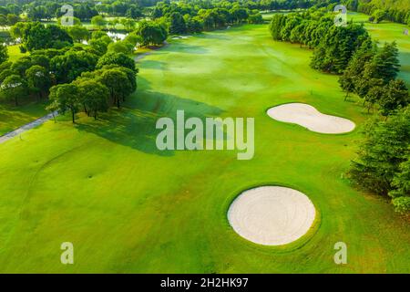 Aerial view of green grass and sand trap on golf course. Stock Photo