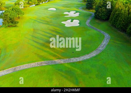 Aerial view of green grass and sand trap on golf course. Stock Photo