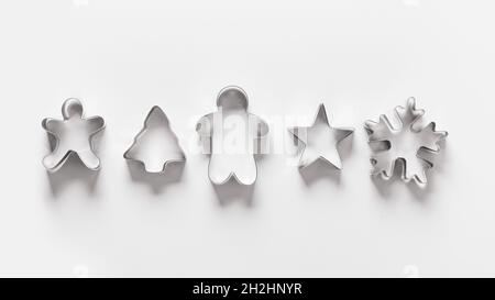 Christmas-themed cookie cutters for gingerbread on white background. Xmas creative concept themed family cooking and preparation for holiday. Banner. Stock Photo
