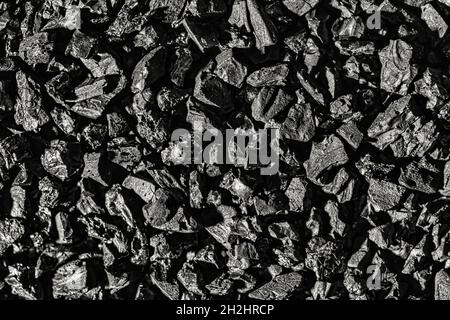 Close-up of black activated carbon texture. Coconut charcoal. Stock Photo