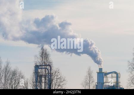 Air pollution toxic smoke fumes from power plant chimneys. Industrial Emission is a major source of greenhouse gas emissions Stock Photo