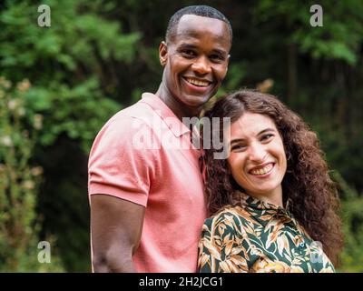 Happy mixed race couple in a forest Stock Photo