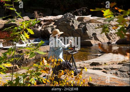 An artist at work in the Jackson Falls - Jackson, New Hampshire, USA Stock Photo