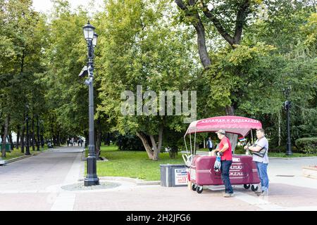 Moscow, Russia - August 23, 2021: people near mobile stall with drinks and ice cream on Strastnoy Boulevard in Moscow city on summer day. Strastnoy Bo Stock Photo