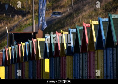 A row of brightly-painted beach huts in Whitby Stock Photo