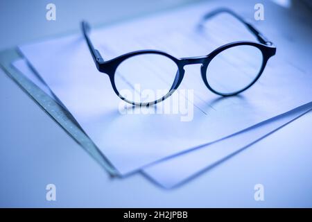 Glasses on paper slight reflection black white Stock Photo