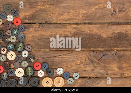 assorted colorful clothes buttons on wooden table Stock Photo