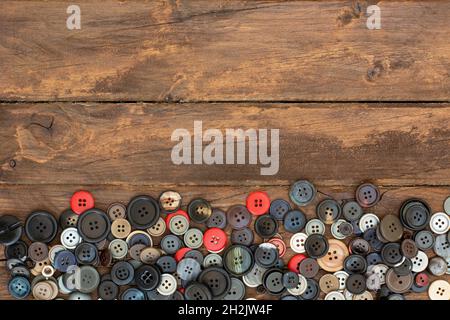 assorted colorful clothes buttons on wooden table Stock Photo