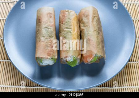 wrapped Nem Cuon, Vietnamese cold rolls close up on gray blue plate Stock Photo