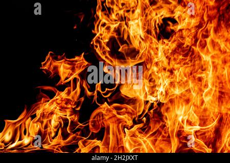 Fire flame texture. Burning material backdrop. Burn effect pattern. Blaze and torch wallpaper. Heat and haze backdrop. Exploison and hot background. Stock Photo
