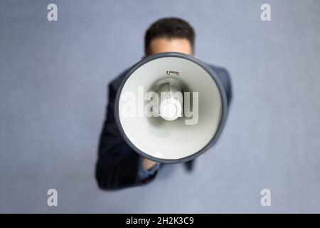 Megaphone Attention Concept. Man Shouting Using Loudspeaker Stock Photo