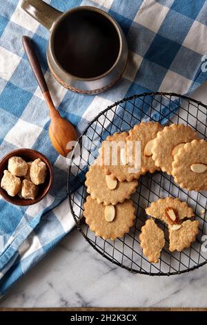 overhead shot of almond cookies on rack and coffee with sugar Stock Photo