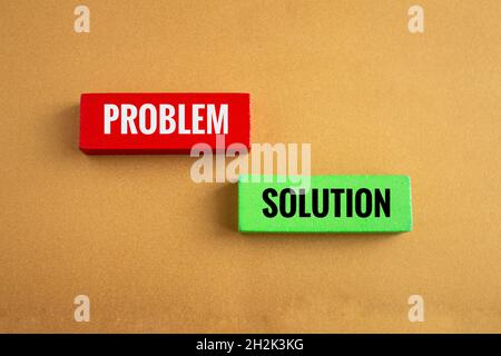 Wooden blocks with problem and solution written on it isolated on colored background. Crisis management and risk concept in business life. Stock Photo