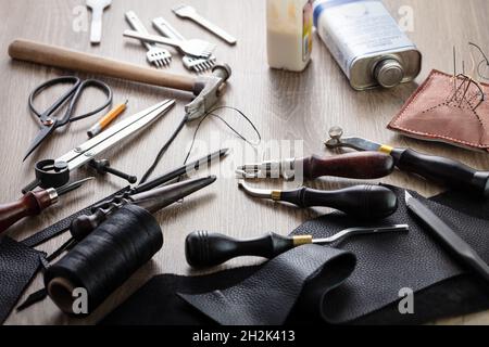 Concept of leather handcraft instruments. Working process Stock Photo