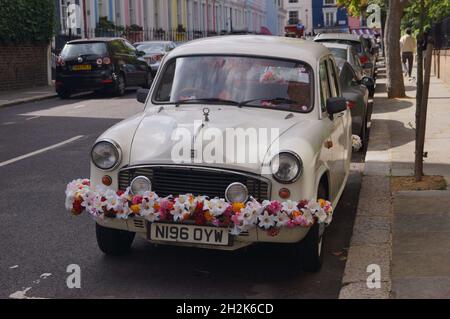 The white Karma Kar cab parked in Ladbroke Grove, London (UK) Stock Photo