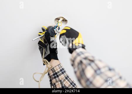 electrician repairing suspend of ceiling lamp at home Stock Photo