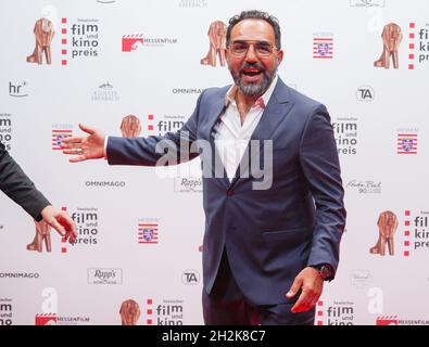 Hessen, Germany. 22nd Oct, 2021. 22 October 2021, Hessen, Offenbach/Main: Actor Adnan Maral stands in the foyer before the award ceremony of the Hessian Film and Cinema Award 2021. Due to the Corona pandemic, the award ceremony will take place on a smaller scale with around 350 invited guests at the Capitol in Offenbach. Photo: Frank Rumpenhorst/dpa Credit: dpa picture alliance/Alamy Live News Stock Photo