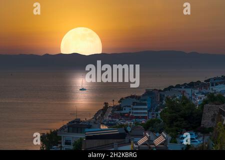 Full moon on Aegean Sea in the evening in Cesme City, Izmir, Turkey Stock Photo