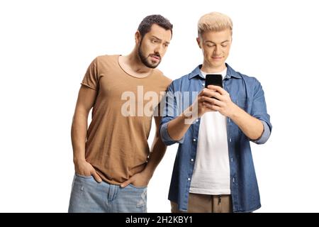 Guy typing on a mobile phone and an angry man spying on him isolated on white background Stock Photo