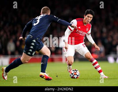 Arsenal's Takehiro Tomiyasu (right) and West Ham United's Aaron Cresswell battle for the ball during the Premier League match at the Emirates Stadium, London. Picture date: Friday October 22, 2021. Stock Photo