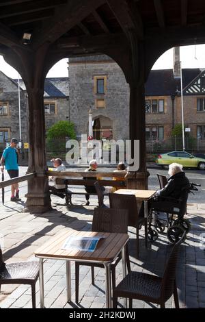 People sitting underneath the Market House, Ledbury, Herefordshire Stock Photo