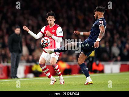 Arsenal's Takehiro Tomiyasu (left) and Aston Villa's Tyrone Mings battle for the ball during the Premier League match at the Emirates Stadium, London. Picture date: Friday October 22, 2021. Stock Photo
