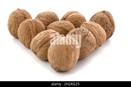 Walnuts in a triangle isolated on white background Stock Photo