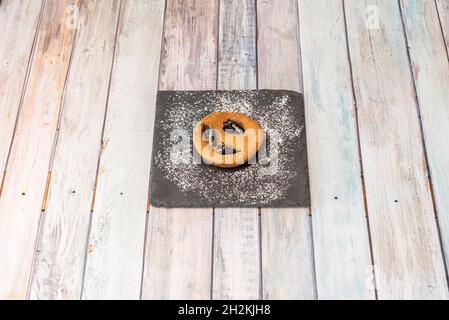 Freshly baked cookie with chocolate chip cookies with icing sugar on black slate plate Stock Photo