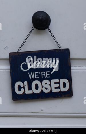 Sorry we are closed sign hanging on a white store doors Stock Photo