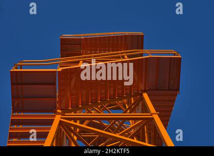 detail of an orange metal fire lookout tower with a blue sky Stock Photo