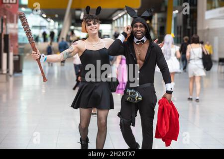 ExCel, London, UK. 22nd Oct, 2021. Two participants arrive in their fun outfits. Cosplayers, fans and visitors once again descend on the ExCel London exhibition centre for MCM Comic Con. MCM London Comic Con returns 22-24 October for a celebration of Pop Culture. Credit: Imageplotter/Alamy Live News Stock Photo