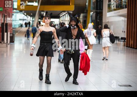 ExCel, London, UK. 22nd Oct, 2021. Two participants arrive in their fun outfits. Cosplayers, fans and visitors once again descend on the ExCel London exhibition centre for MCM Comic Con. MCM London Comic Con returns 22-24 October for a celebration of Pop Culture. Credit: Imageplotter/Alamy Live News Stock Photo