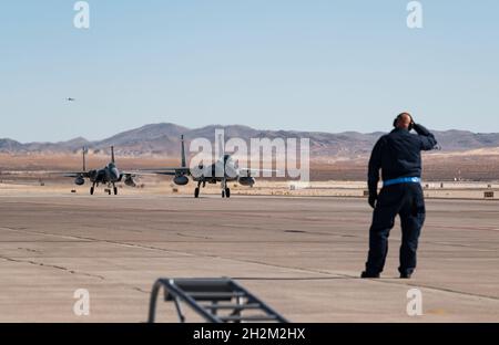 F-15C Eagle fighter jets assigned to the 123rd Fighter Squadron, Portland Air National Guard Base, Oregon, arrive at Nellis Air Force Base, Nevada, Oct. 15, 2021. The aircraft will help support the evaluation of the F-15EX in operationally realistic scenarios. Detachment 6, Air Force Operational Test & Evaluation Center, Nellis AFB, is leading the test along with other Air Force units from Eglin AFB, Florida and Portland Air National Guard Base, Oregon. (U.S. Air Force photo by William R. Lewis) Stock Photo