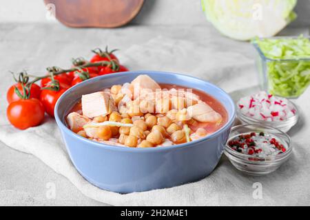 Tasty homemade pozole soup and ingredients on table, closeup Stock Photo