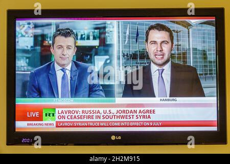 Porto Portugal,television screen tv monitor flat panel,RT Russia Today program,channel breaking Syrian ceasefire news reporter man male Stock Photo