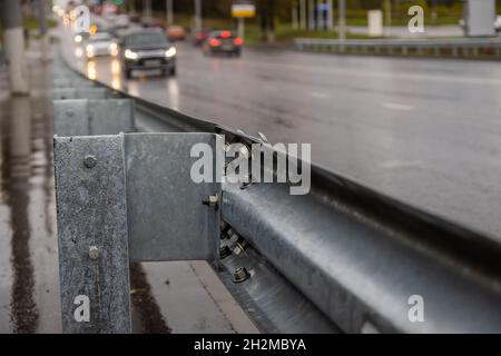 underscrewed nuts and bolts in highway road railing Stock Photo